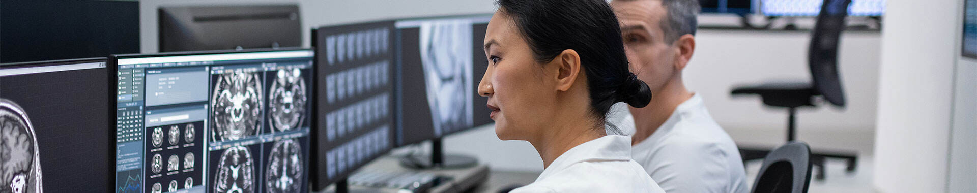 Two radiologists looking at CT scan images